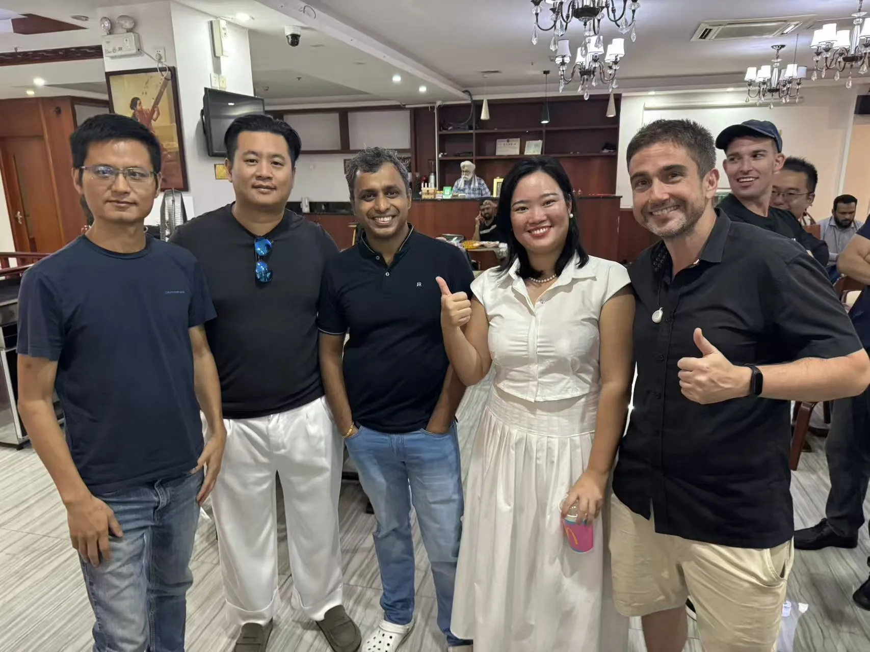 Attendees posing together with thumbs up at the Shenzhen cross border dinner