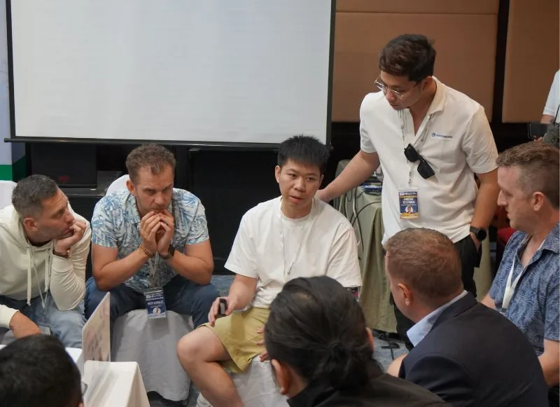 Attendees talking over a shared meal at a past Cross Border Summit